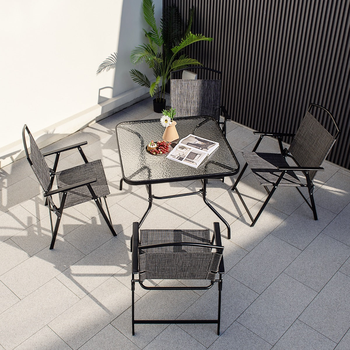 Compact folding chairs save space when stored and make this patio dining set easy to carry