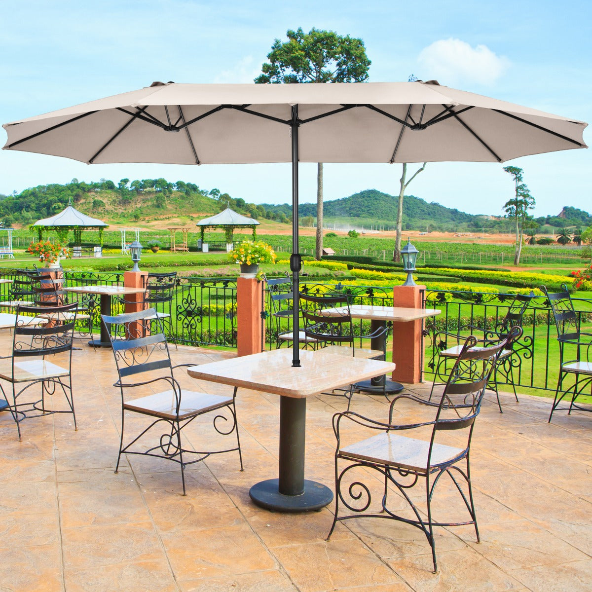 Outdoor twin umbrella includes a fixing strap to keep the folded canopy secure when not in use