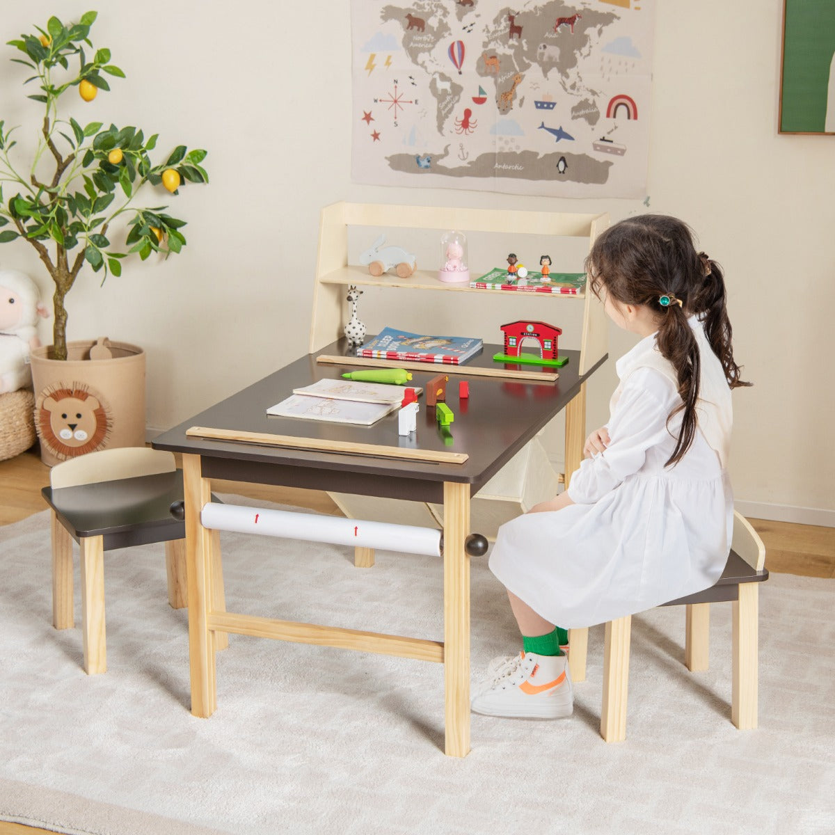 Two large storage bins under the children’s table organize toys, blocks, stationery, and craft materials