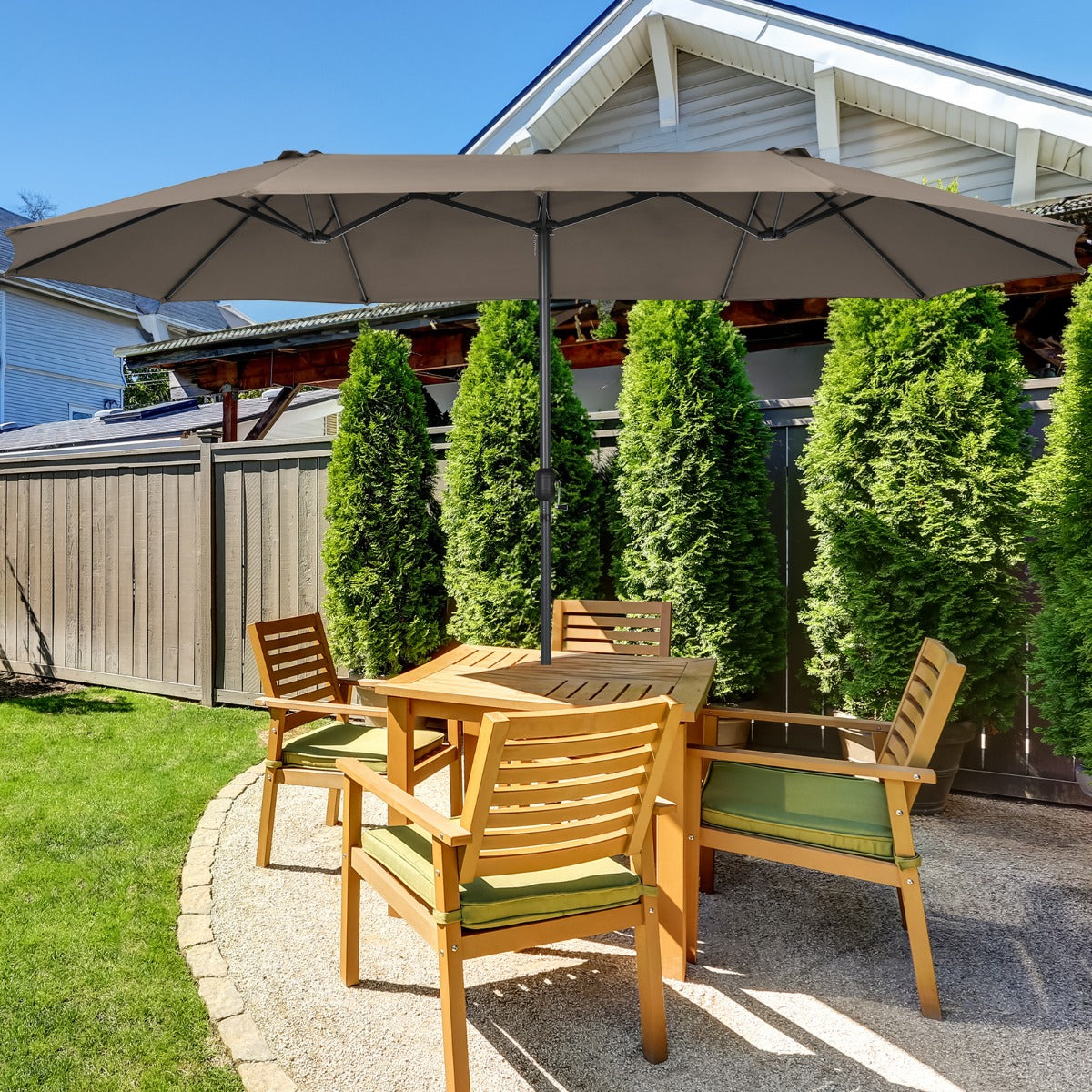 Outdoor twin umbrella includes a fixing strap to keep the folded canopy secure when not in use